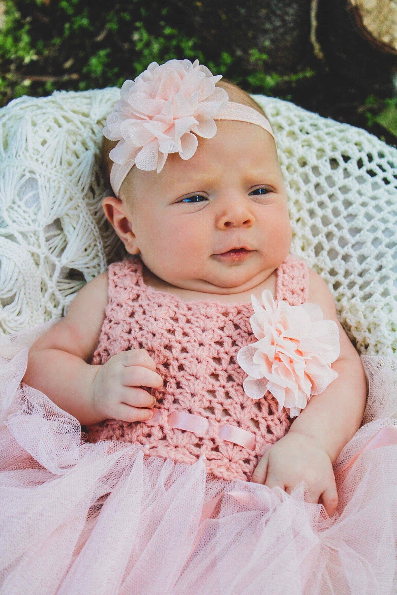 Dahlia is registered to the contest to win money with this photo: baby, baby_toddler_clothing, child, clothing, dress, embellishment, grass, happy, headband, headgear, headpiece, headwear, jewellery, pattern, peach, person, petal, pink, plant, skin