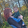 baby, child, adult, parent, holding, smiling, outdoor, autumn, woodland, trees, nature, sunlight, portrait, family, infant, plaid_shirt, red_hair, glasses, arms, happy