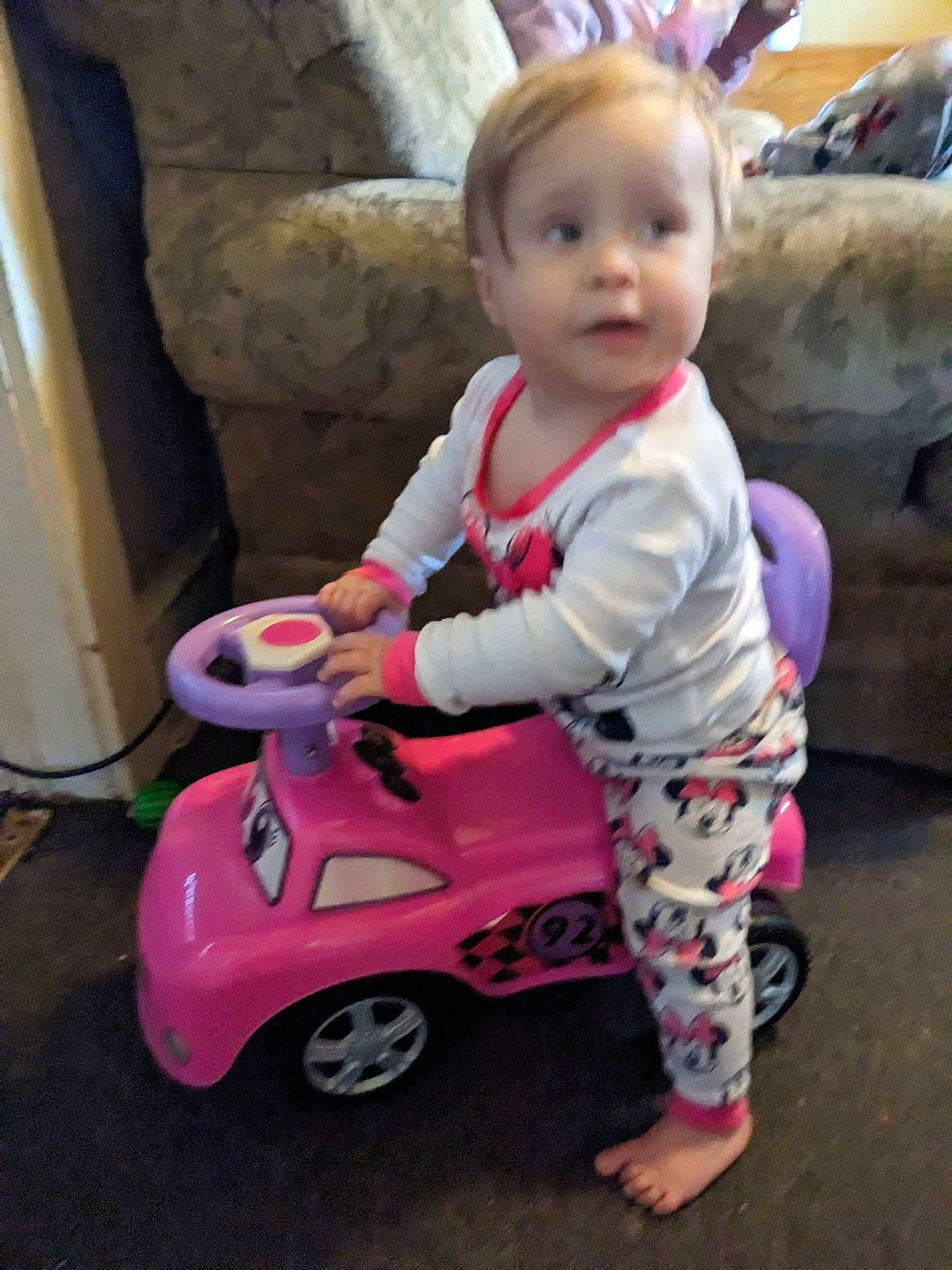 Nova is registered to the contest to win money with this photo: baby, baby_toddler_clothing, child, fun, grass, happy, magenta, motor_vehicle, people, person, pink, play, riding_toy, sleeve, smile, tire, toddler, toy, vehicle, wheel