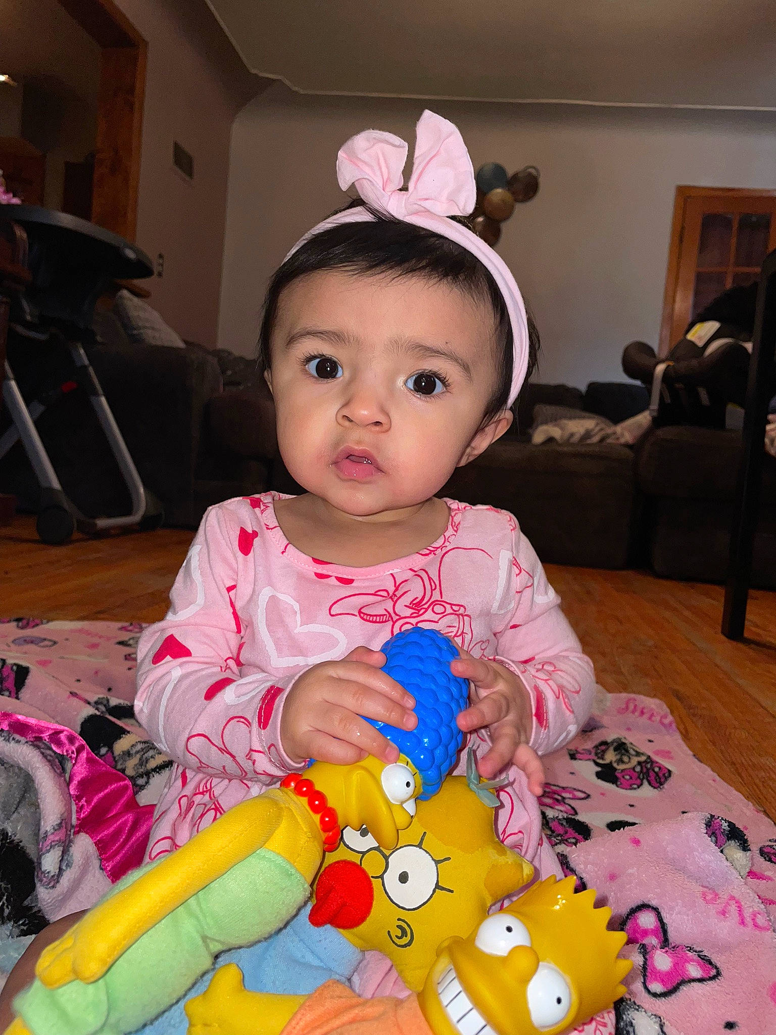 Amora is registered to the contest to win money with this photo: baby, baby_toddler_clothing, cheek, child, costume, event, eye, eyelash, facial_expression, flooring, fun, happy, headband, headpiece, person, pink, room, sitting, skin, toddler