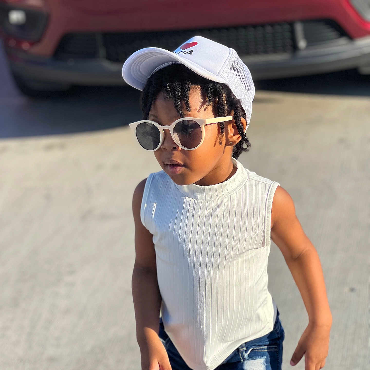 Gianna is registered to the contest to win money with this photo: accessories, baseballcap, cap, car, child, clothing, face, female, girl, hat, head, person, photography, portrait, shorts, sleeve, sunglasses, transportation, vehicle, vest