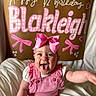 Blakleigh joined the competition — help win amazing prizes! baby, smiling, pink_bow, pink_outfit, happy, child, portrait, celebration, half_birthday, decorations, text, indoor, cute, infant, cheerful, clothing, person, headwear, sitting, joyful