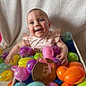 Blakleigh joined the competition — help win amazing prizes! baby, infant, smiling, easter_eggs, colorful, plastic_eggs, basket, blanket, 5_months, celebration, cute, happy, portrait, child, indoors, toy, playful, pink_bib, blue_eyes, holiday