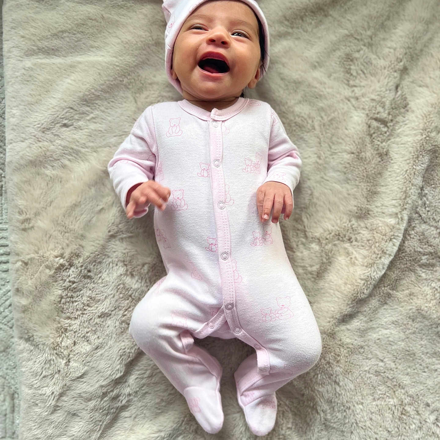 Shanaya joined the competition — help win amazing prizes! adorable, baby, blanket, child, closeup, cozy, cute, footed_pajamas, happy, hat, indoor, infant, lying_down, newborn, pink_onesie, portrait, skin, small_hands, smiling, soft_texture