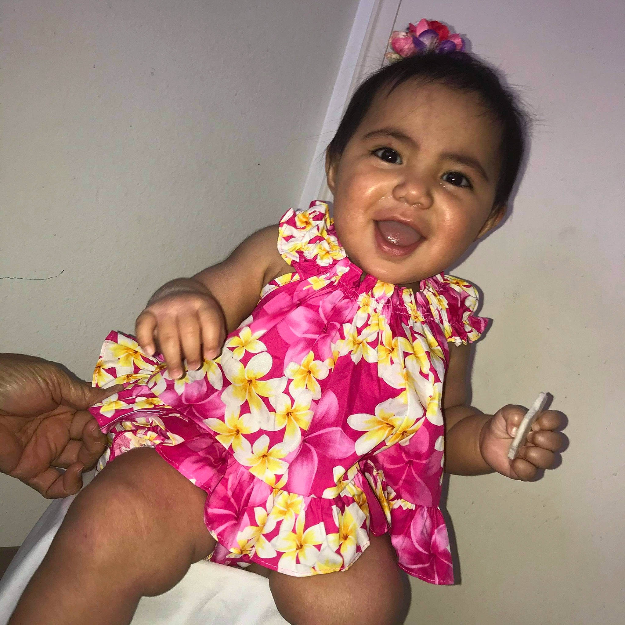 Royalty is registered to the contest to win money with this photo: arm, baby_toddler_clothing, dress, eye, face, finger, gesture, hair, hand, happy, head, human_body, mouth, muscle, neck, person, pink, plant, purple, skin