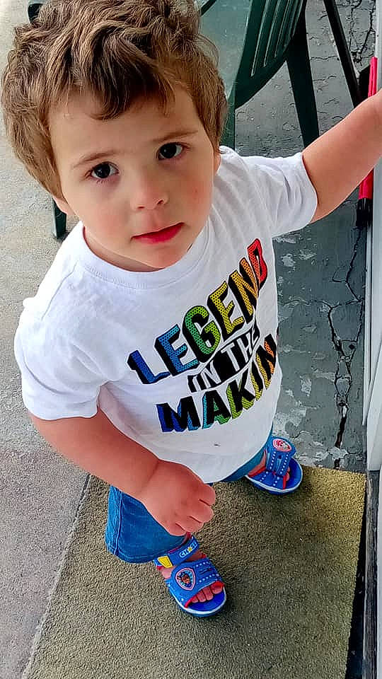 Carson is registered to the contest to win money with this photo: baby, baby_toddler_clothing, blue, child, electric_blue, face, fun, grass, hair, happy, leisure, pattern, person, play, shoe, shorts, sitting, sleeve, t_shirt, toddler