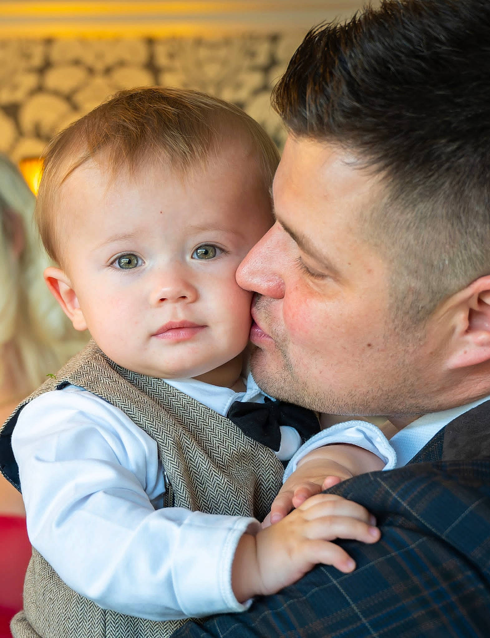Harry is registered to the contest to win money with this photo: baby, cheek, chin, dress_shirt, eye, flash_photography, formal_wear, fun, gesture, hand, happy, human_body, interaction, iris, person, plant, skin, tartan, tie, toddler