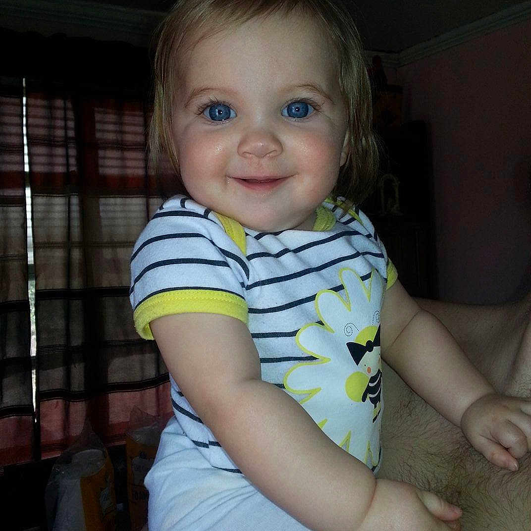 Payten Jacklynn is registered to the contest to win money with this photo: baby, bodypart, clothing, face, happy, head, homedecor, indoors, laughing, mouth, pants, person, photography, portrait, shirt, shorts, sitting, smile, t_shirt, teeth