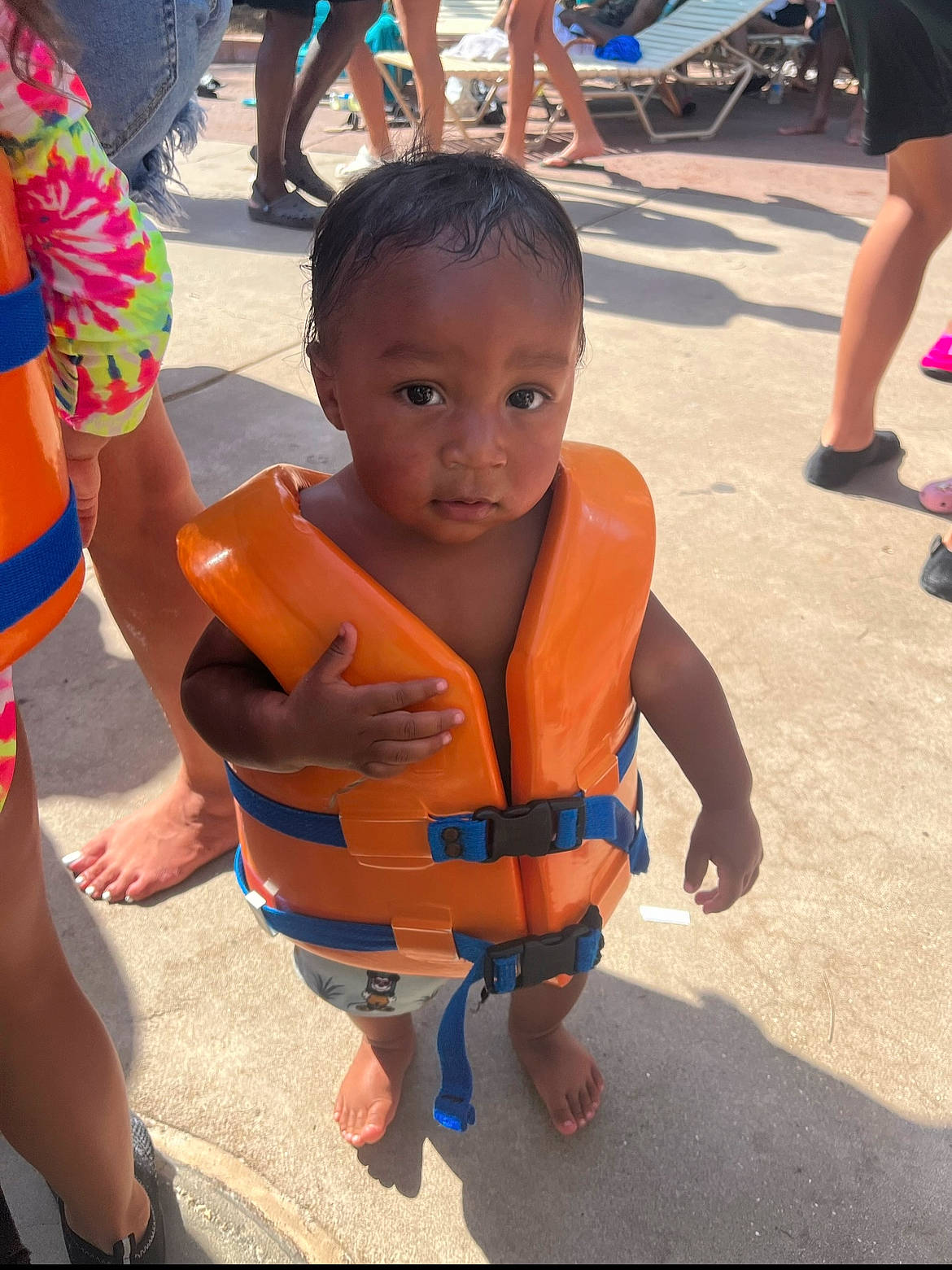 Josiah is registered to the contest to win money with this photo: barechested, barefoot, child, event, foot, fun, happy, human_leg, leisure, orange, person, play, recreation, sandal, shorts, street, t_shirt, thigh, toddler, tourism