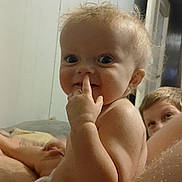Remington joined the competition — help win amazing prizes! baby, background, bare_chest, child, curly_hair, diaper, expression, face, family, finger_in_nose, head, indoor, peeking, person, playful, room, skin, smiling, wall, young_child