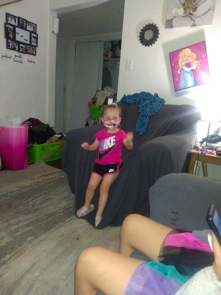 Hylee joined the competition — help win amazing prizes! black, comfort, couch, floor, furniture, hat, interior_design, joint, knee, lap, leg, leisure, living_room, person, picture_frame, pink, purple, shorts, shoulder, t_shirt