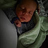 James joined the competition — help win amazing prizes! baby, newborn, sleeping, blanket, striped_clothing, infant, cushion, cozy, soft_texture, peaceful, portrait, child, indoor, resting, person, bed, sleepwear, young, head, hand