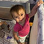 Aurora joined the competition — help win amazing prizes! baby, blanket, child, clothing, curly_hair, cute, expression, footwear_barefoot, furniture, holding, indoors, infant, mesh_side, person, pink_shirt, playpen, smiling, standing, toddler, toy