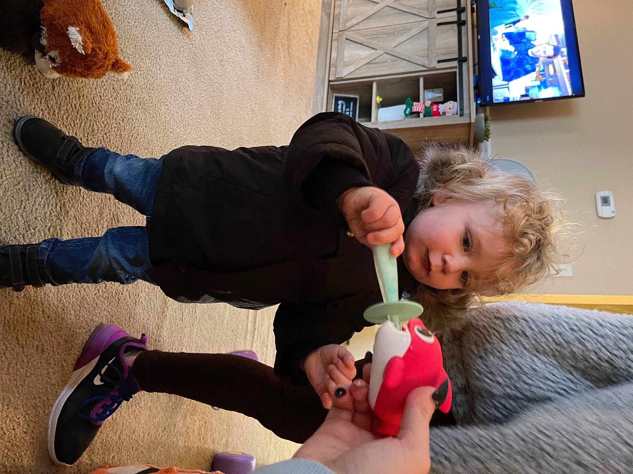 Miles is registered to the contest to win money with this photo: baby_toddler_clothing, cable_television, comfort, couch, display_device, flat_panel_display, jeans, knee, lcd_tv, led_backlit_lcd_display, outdoor_shoe, person, picture_frame, plush, shoe, sock, stuffed_toy, television, television_accessory, television_set