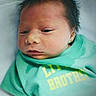 Jaxson joined the competition — help win amazing prizes! newborn, baby, infant, shirt, green_clothing, lying_down, blanket, animal_print, hair, face, skin, portrait, child, cute, sleepy, indoors, soft_lighting, small, person, resting