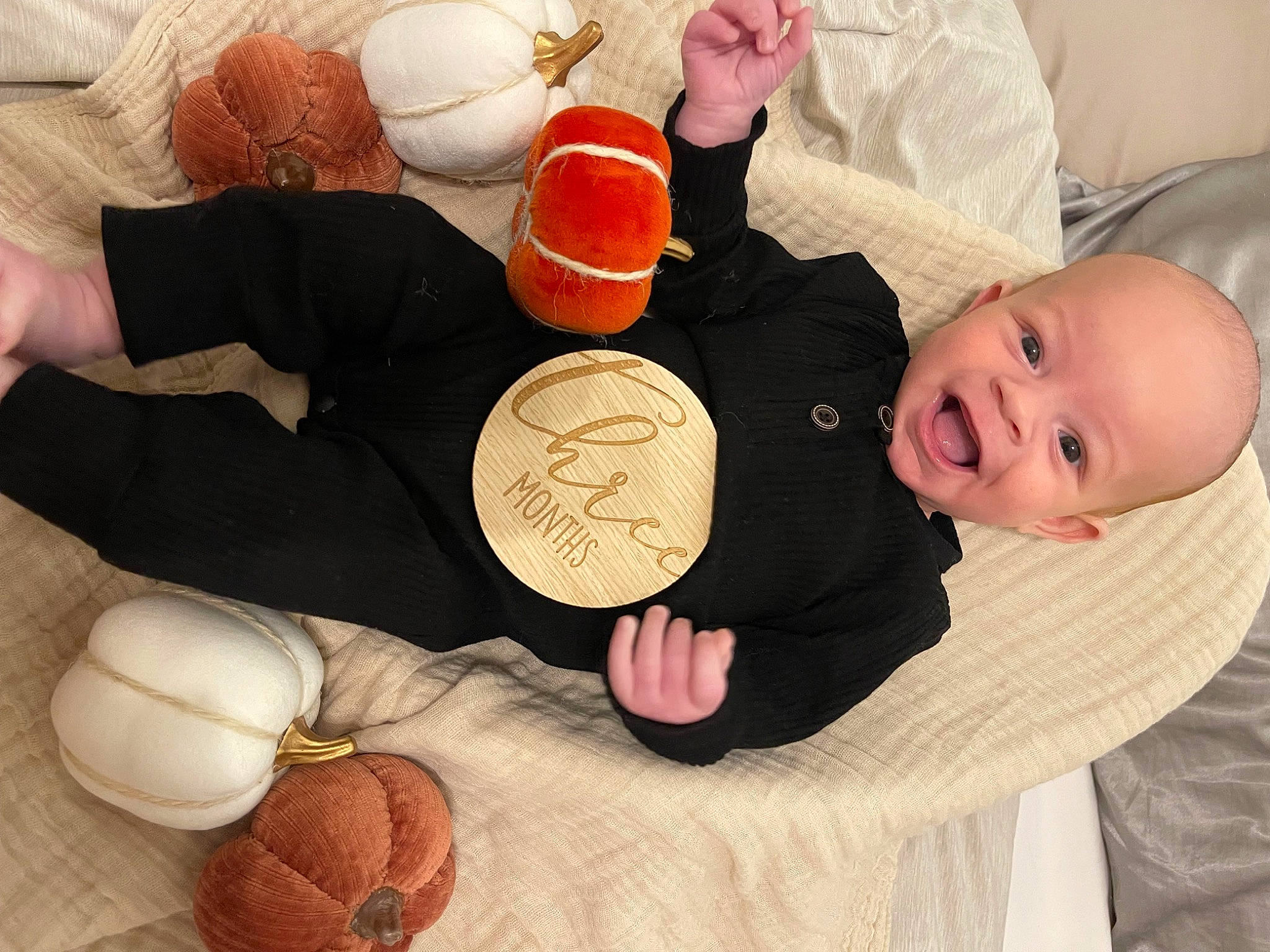 Rhys is registered to the contest to win money with this photo: baby, baby_toddler_clothing, child, comfort, finger, gesture, hand, happy, human_body, linens, nail, orange, person, room, smile, textile, thumb, toddler, tree, wood