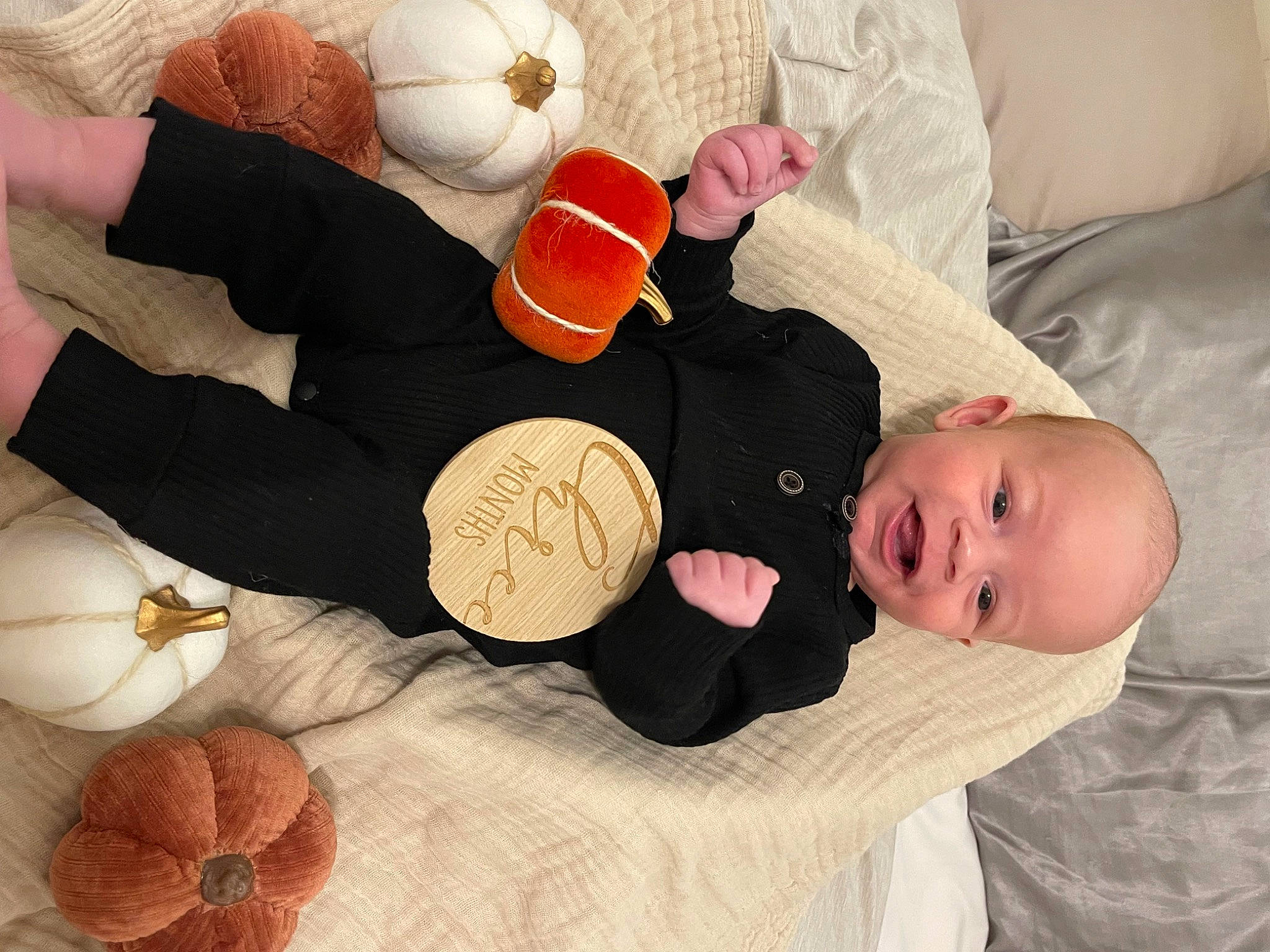 Rhys is registered to the contest to win money with this photo: arm, baby, baby_toddler_clothing, child, comfort, finger, gesture, hand, linens, nail, orange, organ, person, plant, product, room, textile, thigh, thumb, toddler