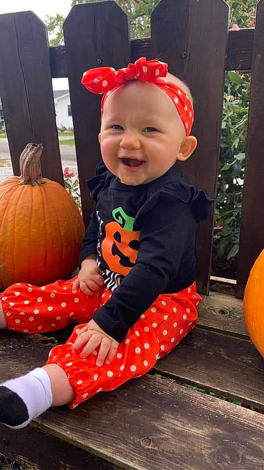 Hazel Rose joined the competition — help win amazing prizes! baby_toddler_clothing, calabaza, cucurbita, dress, eye, facial_expression, happy, head, headwear, human_body, leg, orange, organ, person, photograph, plant, pumpkin, smile, squash, standing
