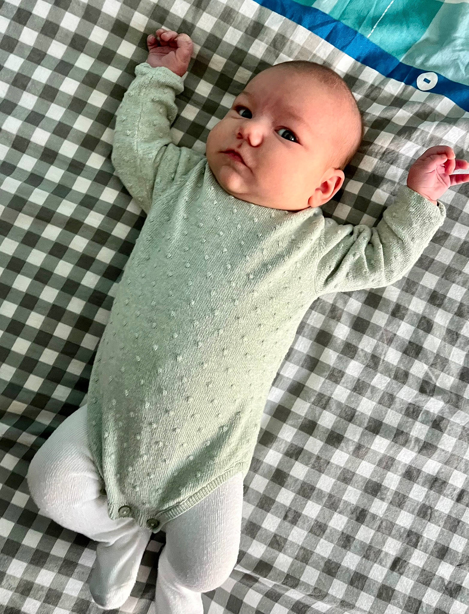 Nina participe au concours pour gagner de l'argent avec cette photo : active_pants, baby, baby_products, baby_toddler_clothing, child, comfort, eye, face, flooring, foot, head, human_leg, knee, linens, pattern, person, sitting, sleeve, thigh, toddler