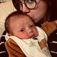 Maylon participe au concours pour gagner de l'argent avec cette photo : baby, woman, glasses, kiss, affection, indoor, closeup, face, love, child, clothing, bib, brown, portrait, person, cuddle, warmth, head, skin, expression