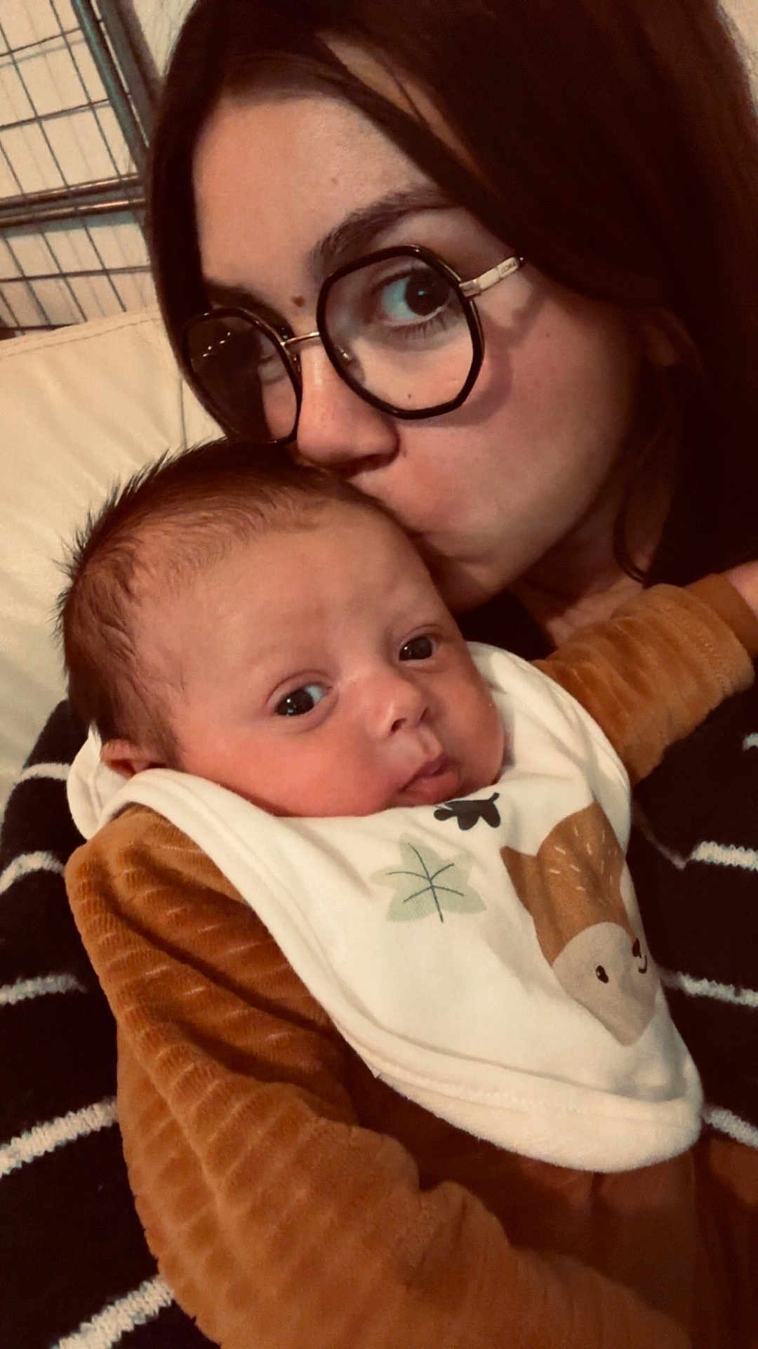 Maylon participe au concours pour gagner de l'argent avec cette photo : baby, woman, glasses, kiss, affection, indoor, closeup, face, love, child, clothing, bib, brown, portrait, person, cuddle, warmth, head, skin, expression