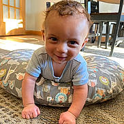 Josiah is registered to the contest to win money with this photo: baby, babycrawling, clothing, crawling, cushion, face, furniture, happy, head, homedecor, indoors, interiordesign, pants, person, photography, portrait, rug, sitting, smile, table