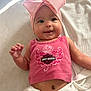 baby, child, pink_bow, headband, tank_top, harley_davidson, smile, lying_down, blanket, cute, infant, skin, face, arm, hand, belly_button, white_blanket, indoors, soft_light, happy