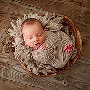 Colter joined the competition — help win amazing prizes! newborn, baby, sleeping, wrapped, wooden_bowl, fluffy_wool, cozy, infant, peaceful, soft, portrait, closeup, indoors, cute, child, resting, wrapped_in_cloth, floor, natural_light, calm