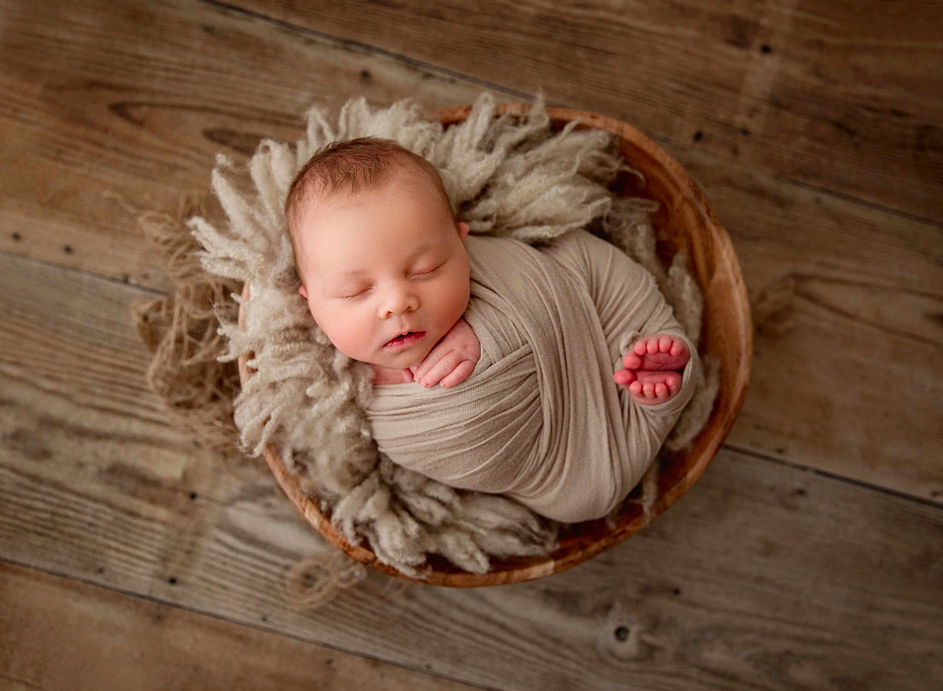 Colter joined the competition — help win amazing prizes! newborn, baby, sleeping, wrapped, wooden_bowl, fluffy_wool, cozy, infant, peaceful, soft, portrait, closeup, indoors, cute, child, resting, wrapped_in_cloth, floor, natural_light, calm