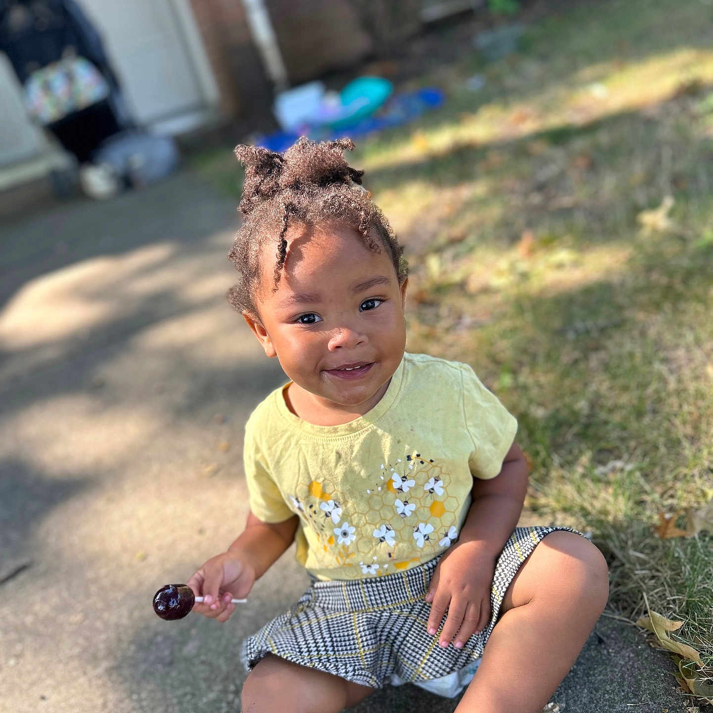 Esme is registered to the contest to win money with this photo: backyard, child, city, clothing, face, female, girl, grass, head, person, photography, plant, portrait, road, shorts, sitting, smokepipe, street, summer, urban