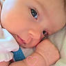 Raeleighana is registered to the contest to win money with this photo: baby, infant, closeup, face, skin, arm, hand, eyes, sleepy, cute, newborn, portrait, lying_down, soft_light, pink_heart, resting, expression, flesh_tone, peaceful, small