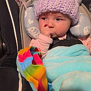 Raeleighana joined the competition — help win amazing prizes! baby, car_seat, hat, knit_hat, blanket, thumb_sucking, infant, child, cute, cozy, colorful_blanket, purple, blue, rainbow, warm_clothing, indoor, seatbelt, soft_toys_pattern, close_up, portrait