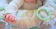 Raeleighana is registered to the contest to win money with this photo: baby, baby_seat, child, childhood, cushion, cute, face, floor_carpet, footwear, hand, home, indoor, infant, pastel_colors, patterned_fabric, soft_toys, striped_clothing, surprised_expression, toy, white_socks