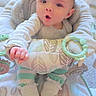 baby, infant, surprised_expression, baby_seat, toy, pastel_colors, striped_clothing, white_socks, cushion, indoor, floor_carpet, child, face, hand, footwear, home, soft_toys, patterned_fabric, cute, childhood