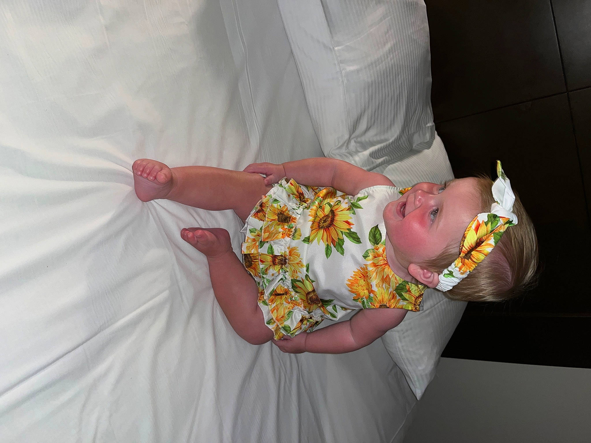 Laurencie is registered to the contest to win money with this photo: baby, baby_products, baby_toddler_clothing, child, comfort, dress, event, fun, happy, human_body, linens, peach, person, pink, product, room, rose, sitting, skin, textile