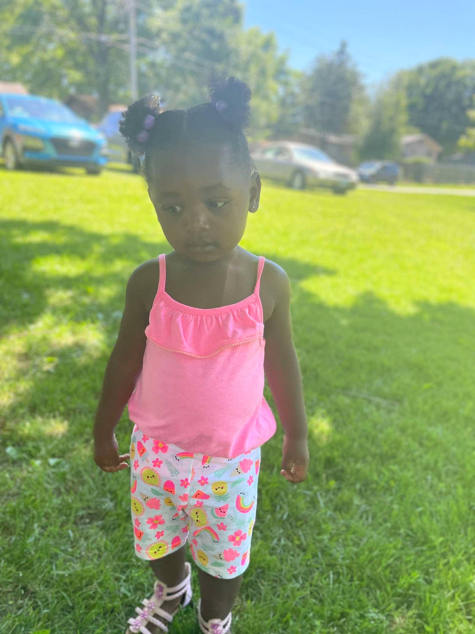 Juju is registered to the contest to win money with this photo: baby_toddler_clothing, car, eye, fun, grass, grassland, happy, leaf, leisure, meadow, natural_environment, people_in_nature, person, pink, plant, shorts, sky, sleeve, toddler, tree