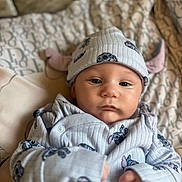 Albie-Joseph joined the competition — help win amazing prizes! baby, bed, blanket, clothing, cozy, cute, expression, face, hat, indoor, infant, looking, lying_down, onesie, pattern, person, skin, sleepwear, soft_light, young