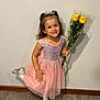 Holland is registered to the contest to win money with this photo: child, clothing, dress, face, female, flower, flowerarrangement, flowerbouquet, girl, happy, head, person, photography, plant, portrait, pottedplant, sitting, sleeve, smile, standing