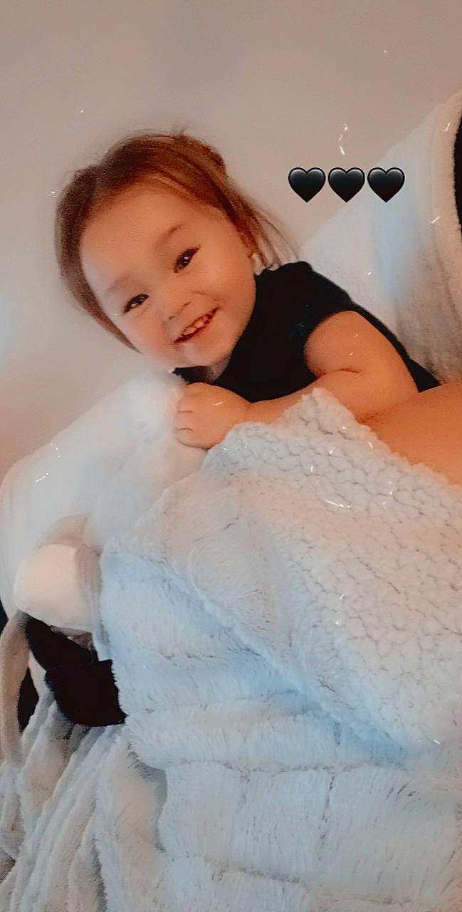 Haylie is registered to the contest to win money with this photo: abdomen, baby, baby_toddler_clothing, child, comfort, event, flash_photography, formal_wear, fun, happy, joy, linens, pattern, peach, person, pink, portrait_photography, sitting, skin, sleeve