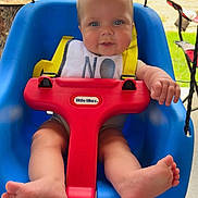 Coleson joined the competition — help win amazing prizes! baby, child, swing, blue_swing, red_swing, yellow_harness, outdoor, backyard, grass, wooden_shed, tractor, barefoot, happy, seated, playtime, daylight, infant, smiling, cute, sunny