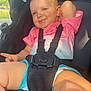 toddler, child, stroller, seatbelt, pink_shirt, blue_shorts, smile, peace_sign, baby, outdoor, sunlight, face, skin, legs, arm, happy, relaxed, casual, cute, daylight