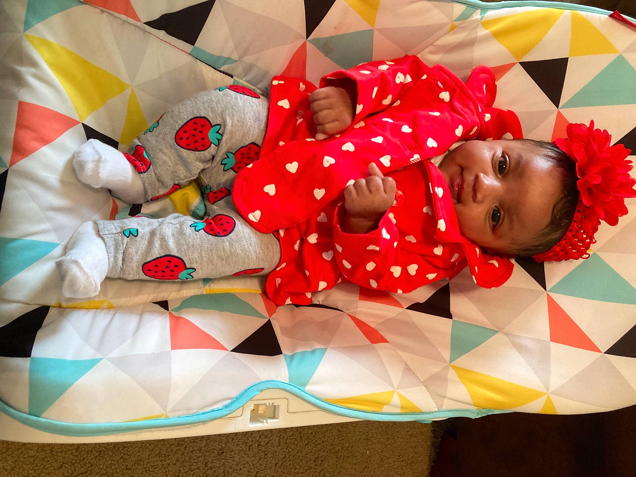 Imani is registered to the contest to win money with this photo: baby, baby_products, baby_toddler_clothing, carmine, child, event, fun, happy, leisure, linens, magenta, pattern, person, petal, pink, product, red, room, smile, textile