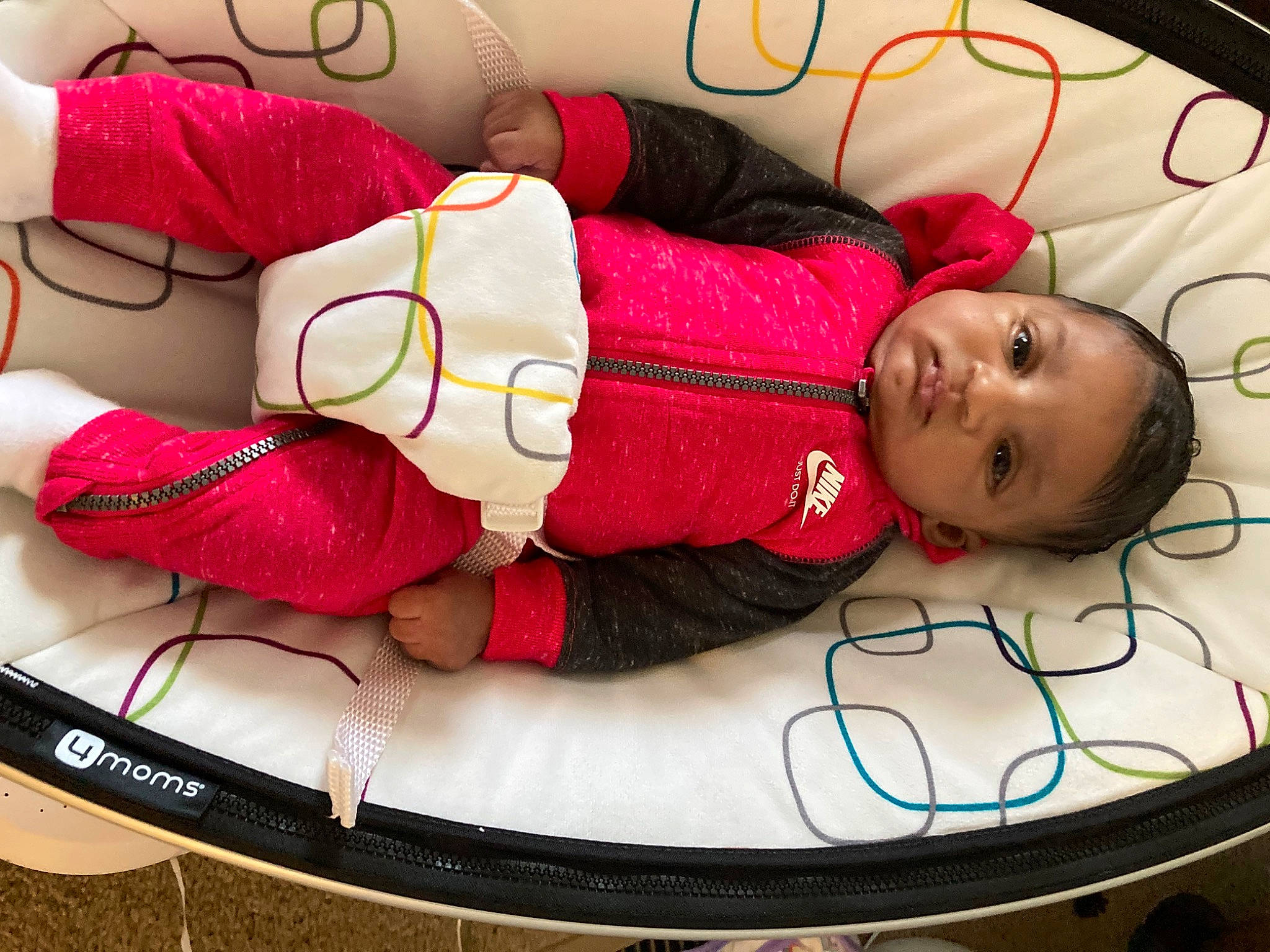 Imani is registered to the contest to win money with this photo: baby, baby_products, baby_toddler_clothing, bag, beauty, child, comfort, flooring, human_leg, linens, magenta, mouth, pattern, person, photograph, pink, red, textile, thigh, toddler