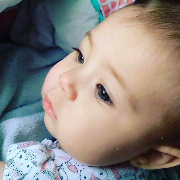 Maddie is registered to the contest to win money with this photo: baby, baby_toddler_clothing, cheek, close_up, comfort, ear, eyelash, forehead, grass, happy, human_body, iris, lip, no_expression, nose, pattern, person, portrait_photography, skin, sleeve