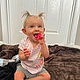 toddler, child, baby, toy, pink_ball, smiling, happy, sitting, indoor, blanket, brown_blanket, water_bottle, casual_clothing, shorts, tshirt, pigtails, blue_eyes, door, floor, playtime
