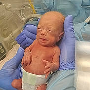 River joined the competition — help win amazing prizes! newborn, baby, infant, hospital, incubator, medical, premature_baby, sleepy, face, portrait, gloves, healthcare, blue_blanket, diaper, umbilical_care, bed, nursery, indoors, photography, human