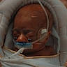 River is registered to the contest to win money with this photo: newborn, baby, sleeping, hospital, bassinet, swaddled, blanket, medical_tubing, oxygen_tube, medical_monitoring, infant, portrait, close_up, peaceful, eyes_closed, face, head, indoors, healthcare, cozy