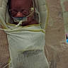River is registered to the contest to win money with this photo: newborn, infant, baby, sleeping, hospital, neonatal_care, bassinet, blanket, swaddle, medical_equipment, oxygen_tube, nasal_cannula, monitoring, portrait, face, indoors, healthcare, premature_baby, resting, bed