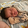 Kylan is registered to the contest to win money with this photo: baby, sleeping, blanket, bed, bedding, infant, face, sleep, peaceful, curly_hair, child, pajamas, soft, resting, closeup, toddler, cushion, cute, indoors, comfort