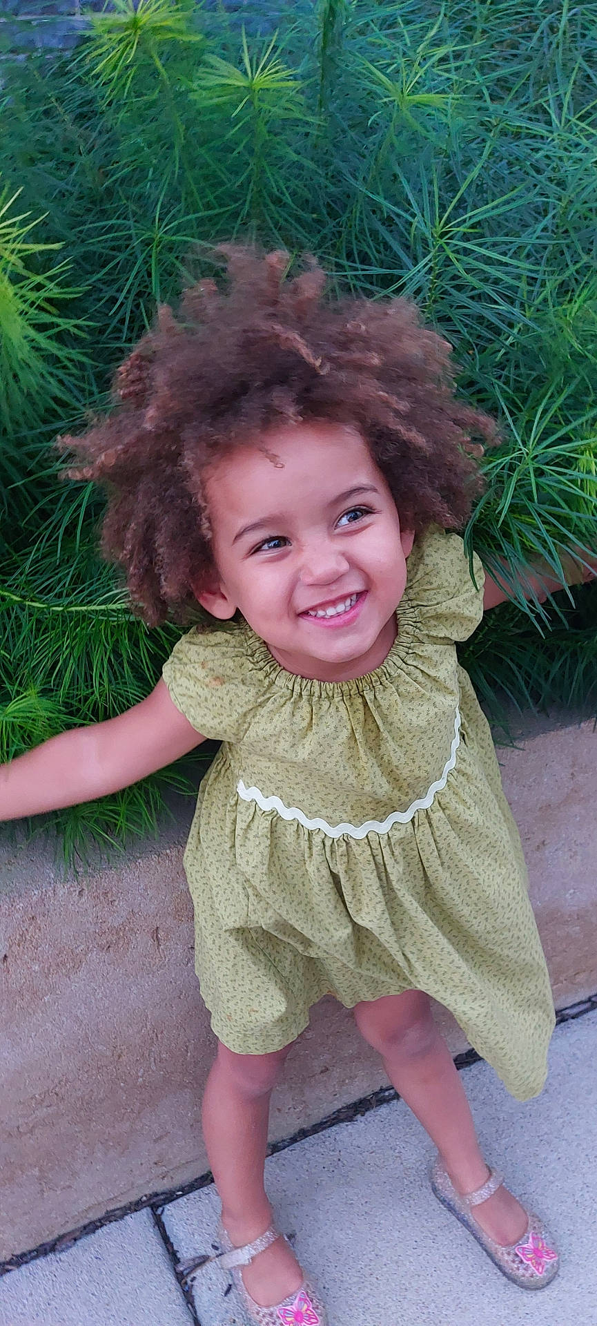 Ella joined the competition — help win amazing prizes! accessories, blouse, child, clothing, dress, face, female, footwear, girl, grass, happy, head, person, photography, plant, portrait, sandal, shoe, smile, tree